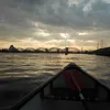 Skats no laivas uz Rīgas tiltiem krēslā